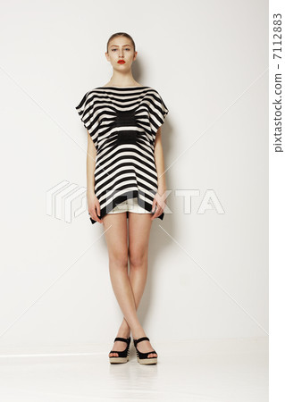 Attitude. Modern Classy Woman in Grey Elegant Clothing. Crossed Legs Attitude. Modern Classy Woman in Grey Elegant Clothing. Crossed Legs 7112883