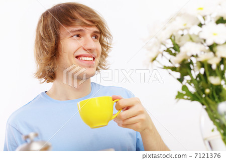 Young happy man drinking tea Young happy man drinking tea 7121376