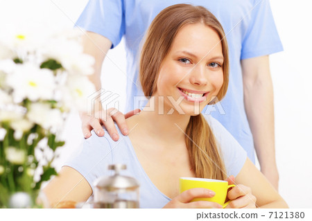 Beautiful young woman drinking tea Beautiful young woman drinking tea 7121380
