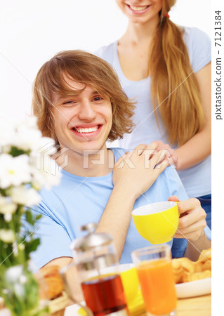 Young happy man drinking tea Young happy man drinking tea 7121384