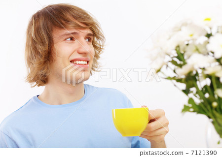 Young happy man drinking tea Young happy man drinking tea 7121390
