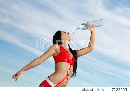 Young female sport girl with a bottle of water 7122235