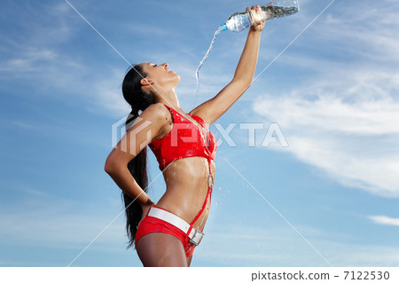 Young female sport girl with a bottle of water Young female sport girl with a bottle of water 7122530