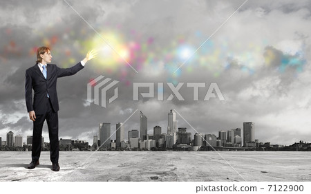 Businessman with colourful light beam in his hands 7122900