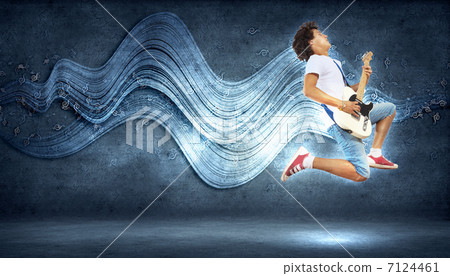 young man playing on electro guitar and jumping young man playing on electro guitar and jumping 7124461