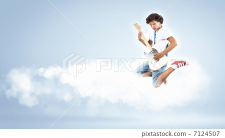 young man playing on electro guitar and jumping young man playing on electro guitar and jumping 7124507