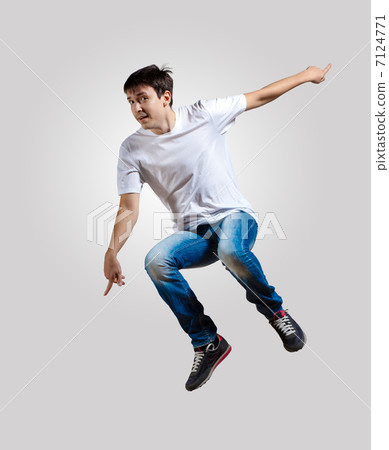 Young man dancing and jumping 7124771