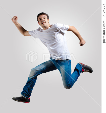 Young man dancing and jumping 7124773