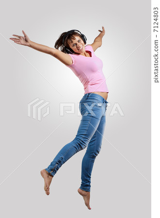 young woman dancing and jumping 7124803