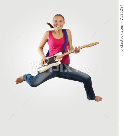 young woman playing on electro guitar and jumping young woman playing on electro guitar and jumping 7125254
