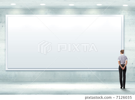Business person standing near a blank billboard Business person standing near a blank billboard 7126035