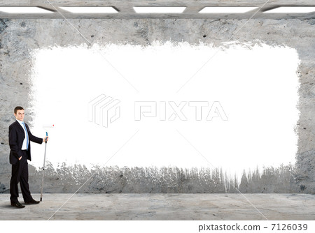 Business person standing near a blank billboard 7126039