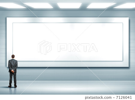Business person standing near a blank billboard 7126041