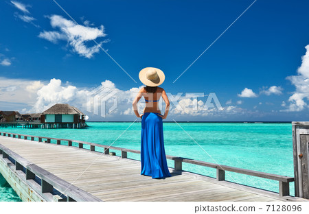 Woman on a beach jetty at Maldives Woman on a beach jetty at Maldives 7128096