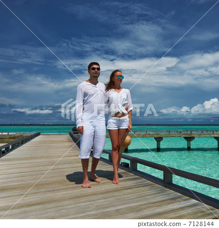 Couple on a beach jetty at Maldives 7128144