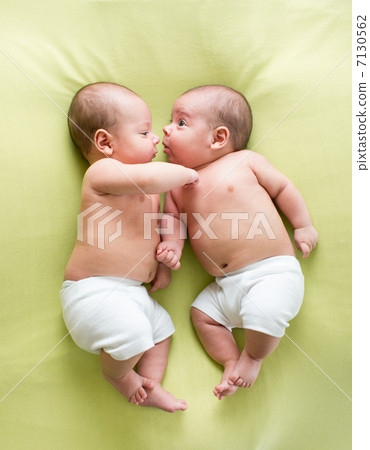 funny twins brothers babies lying on green 7130562