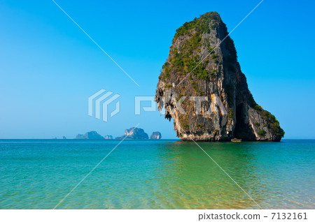 Tropical beach landscape with rock formation island and ocean 7132161