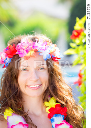 Woman wearing hawaiian flowers garland Woman wearing hawaiian flowers garland 7133729