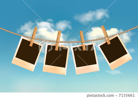 Retro photos hanging on a rope in front of a blue sky with cloud Retro photos hanging on a rope in front of a blue sky with cloud 7135661