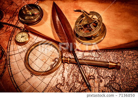 Vintage magnifying glass lies on an ancient world map 7136850