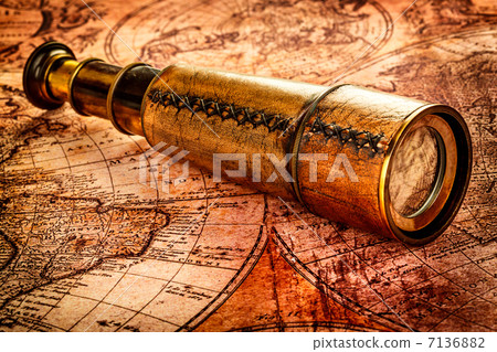 Vintage spyglass lies on an ancient world map Vintage spyglass lies on an ancient world map 7136882