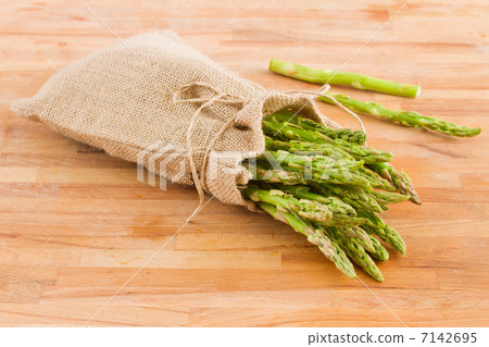 green asparagus pouch  on table 7142695