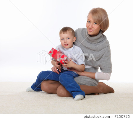 mother and son holding a present mother and son holding a present 7150725