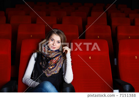 Young girl in cinema watching movie Young girl in cinema watching movie 7151388