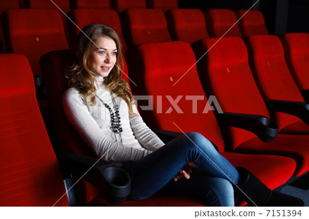 Young girl in cinema watching movie Young girl in cinema watching movie 7151394