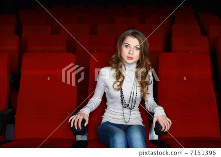 Young girl in cinema watching movie Young girl in cinema watching movie 7151396