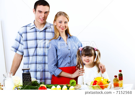 family with a daughter cooking together at home family with a daughter cooking together at home 7152568
