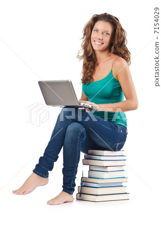Student with netbook sitting on books 7154029