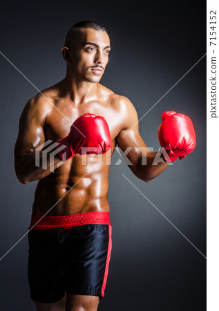 Boxer with red gloves in dark room Boxer with red gloves in dark room 7154152