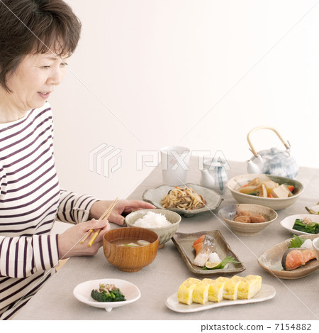 Senior woman eating breakfast 7154882