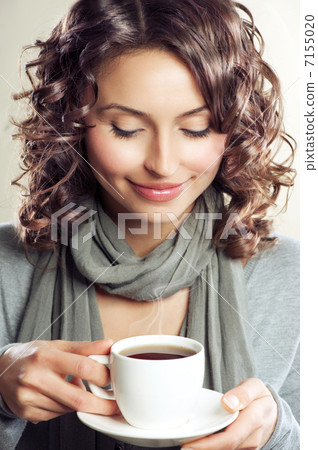 Beautiful Woman drinking Coffee or Tea 7155020