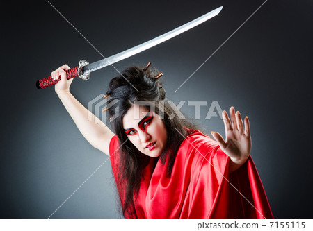 Female sword warriod in dark studio 7155115