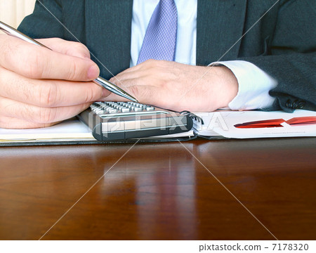 Businessman with calculator 7178320
