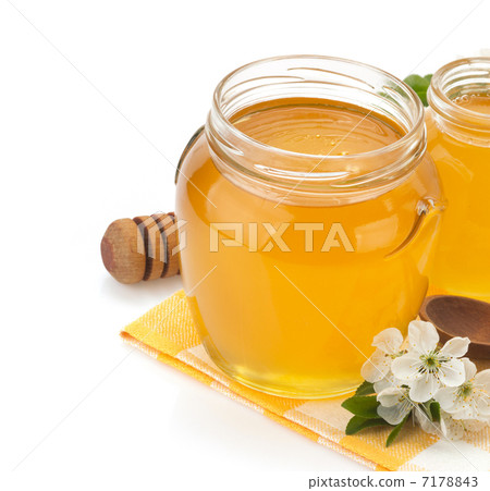 glass jar full of honey and stick glass jar full of honey and stick 7178843