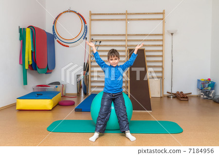 Child is therapeutic exercises in the gym Child is therapeutic exercises in the gym 7184956