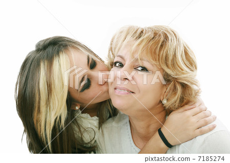 Closeup of young girl kissing her mom isolated on a white backgr 7185274