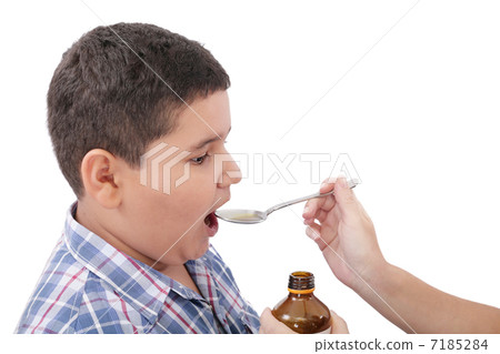 Child taking cough medicine because of the flu Child taking cough medicine because of the flu 7185284