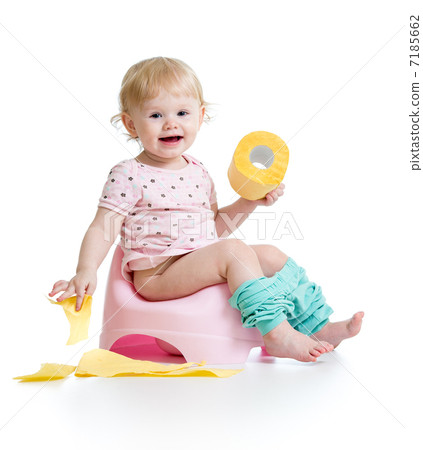 smiling baby sitting on chamber pot with toilet paper roll 7185662