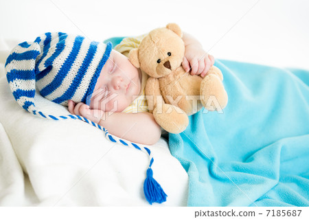 sleeping baby boy with toy 7185687