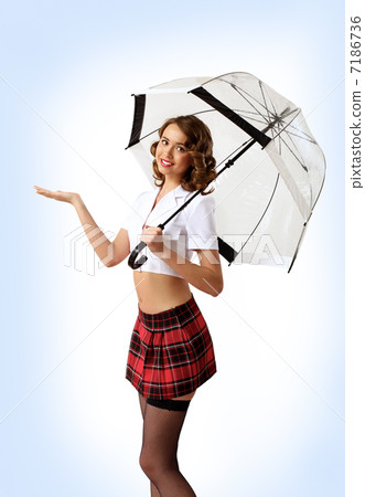Woman dressed in retro style with umbrella 7186736