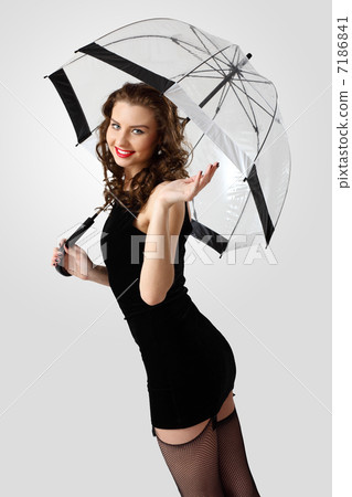 Woman dressed in retro style with umbrella 7186841