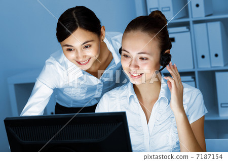 Young woman in business wear and headset Young woman in business wear and headset 7187154