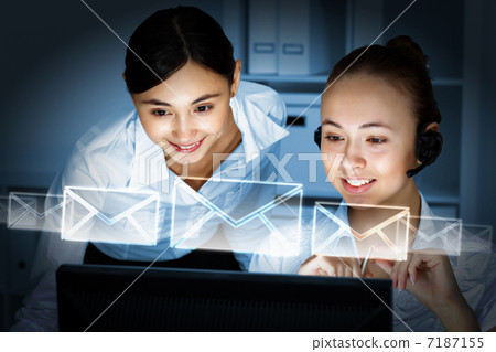 Young woman in business wear and headset Young woman in business wear and headset 7187155