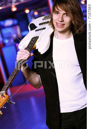 Young guitar player performing in night club Young guitar player performing in night club 7187865