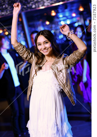 Young woman having fun at nightclub disco 7187923