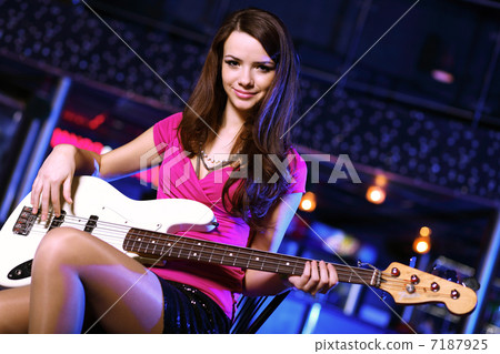 Young guitar player performing in night club Young guitar player performing in night club 7187925